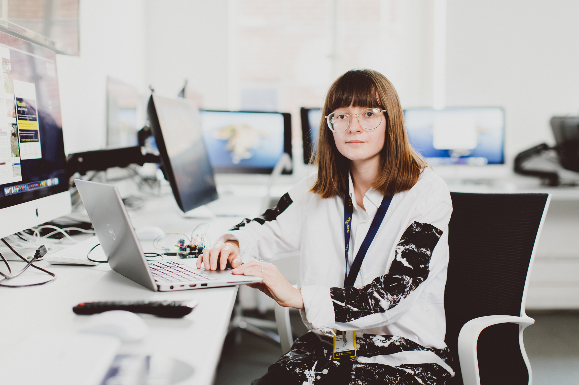 Lecturer Emily Godden sitting at a desk in a computer lab
