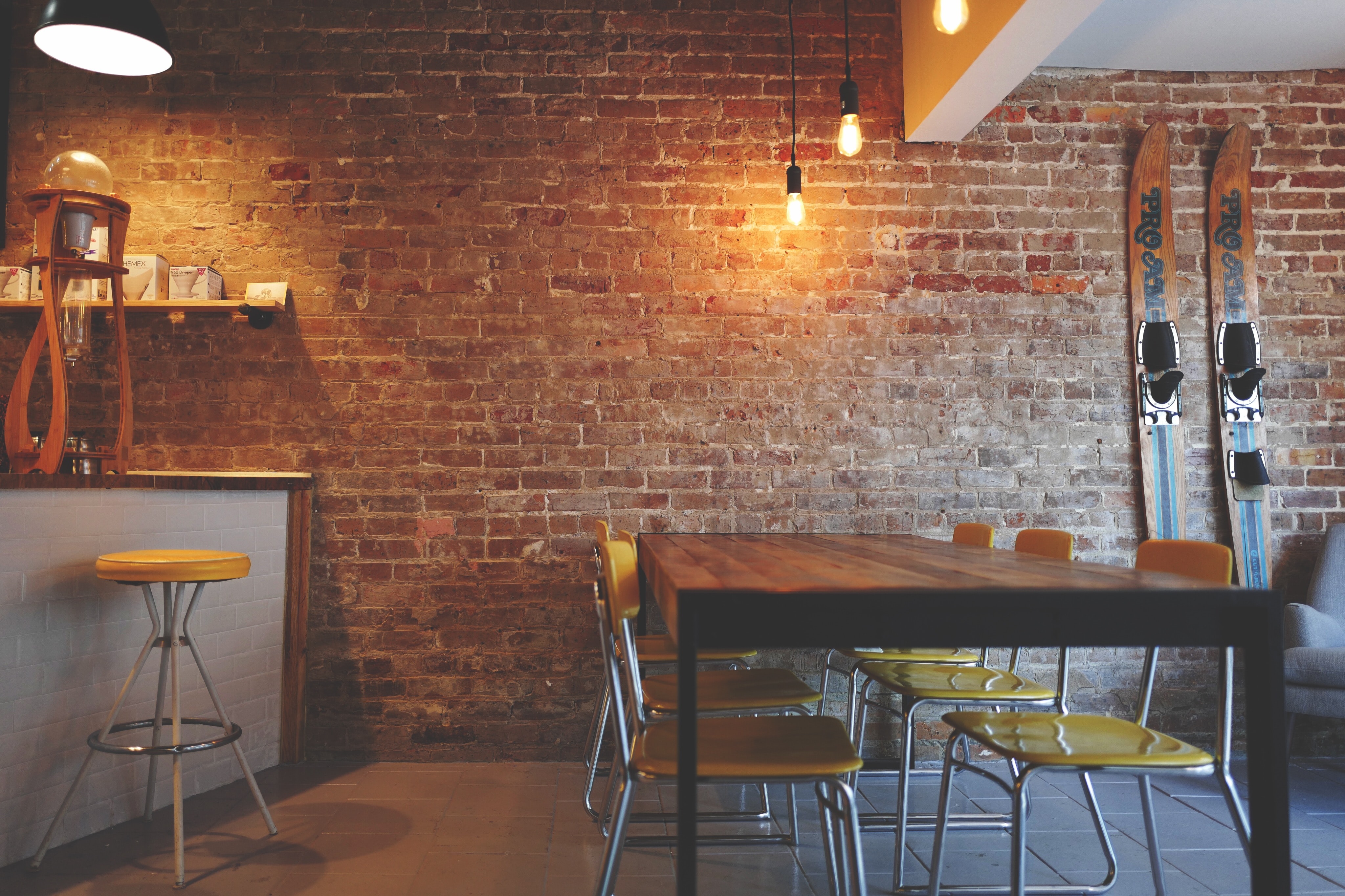 A photo of table and chairs inside of a cafe.