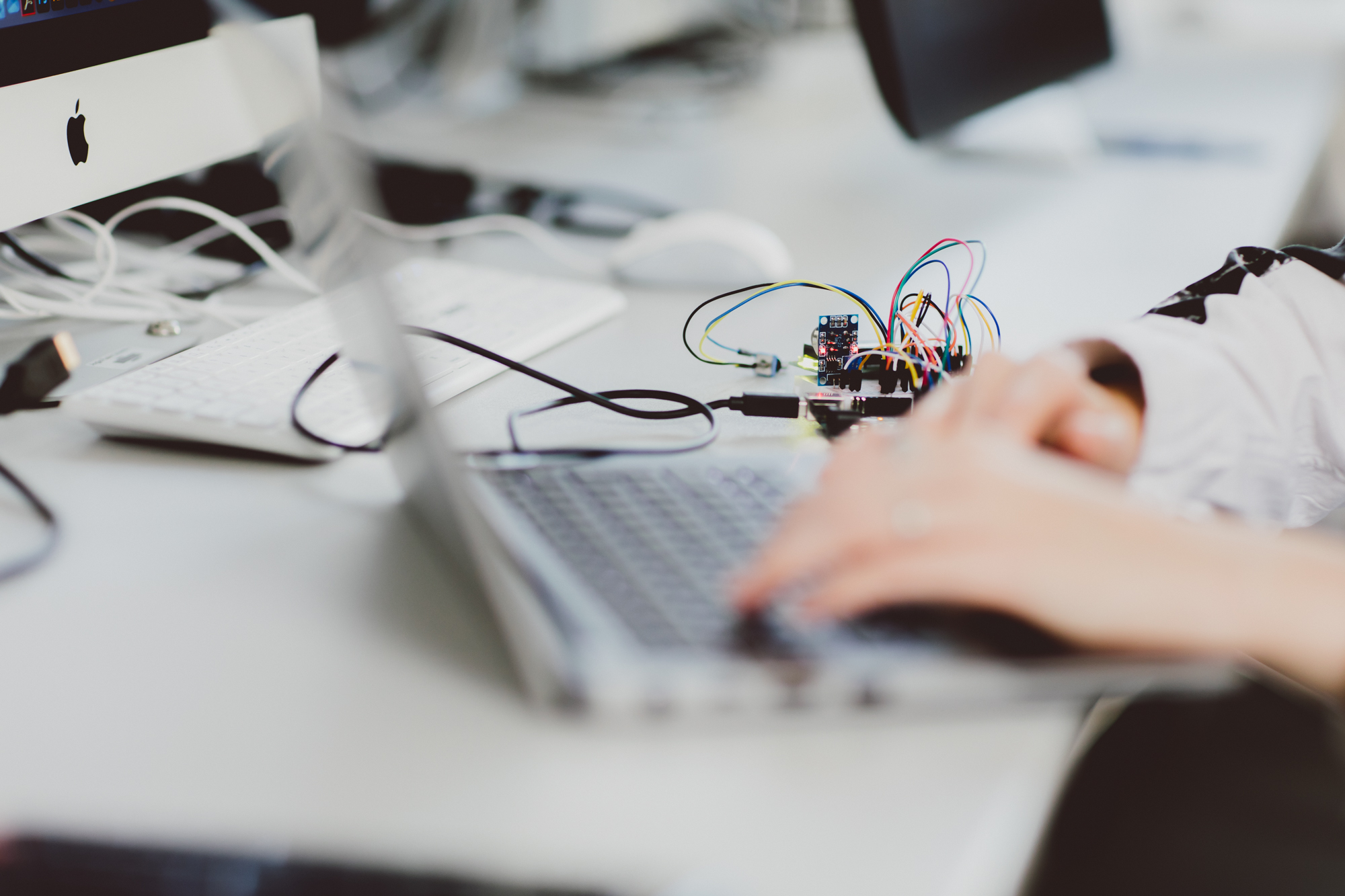 Close up of someone's hands on a laptop keyboard