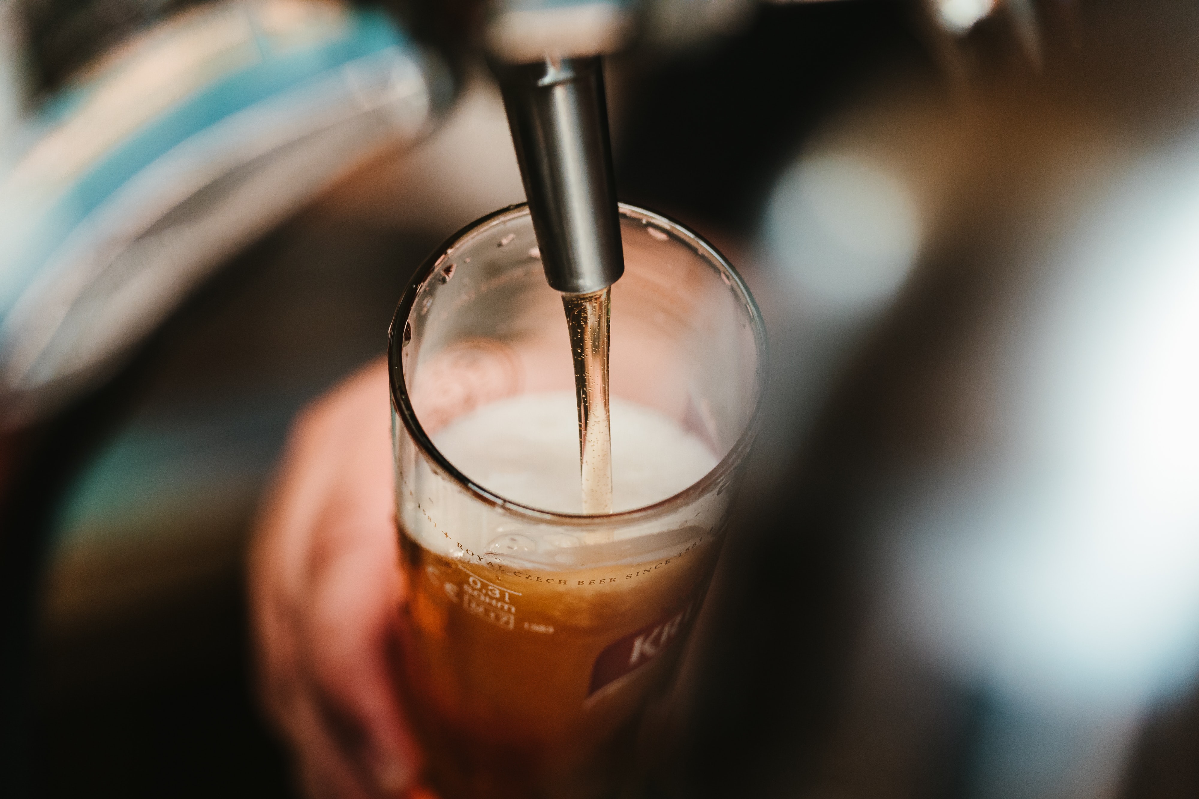 Beer being poured from a tap into a pint glass.