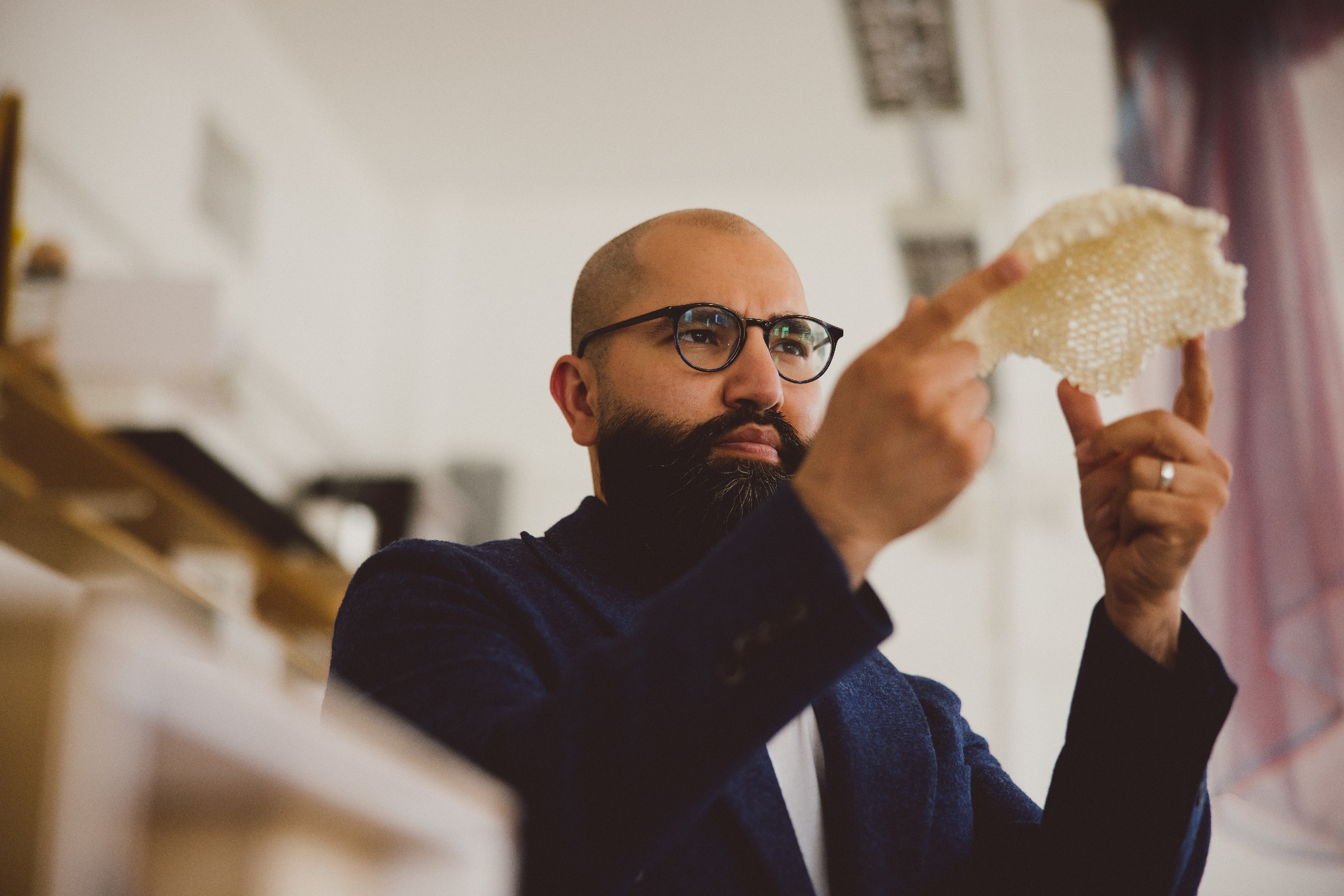 Idrees Rasouli holding up a honeycomb