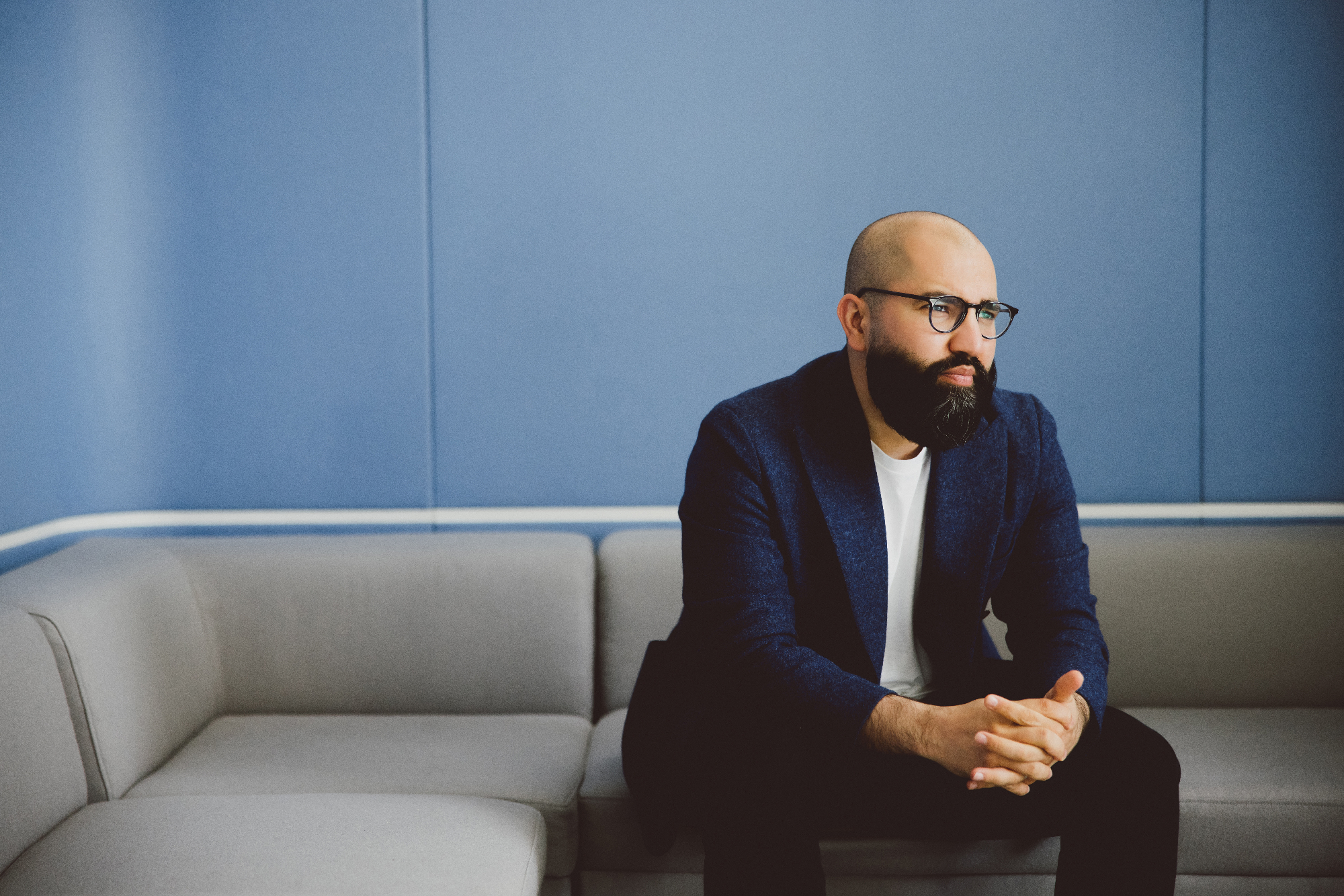 Idrees Rasouli sitting on a corner sofa
