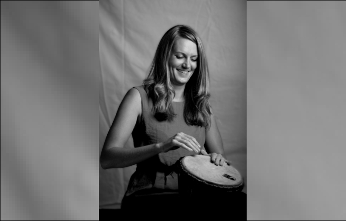 Rosie Axon playing a bongo