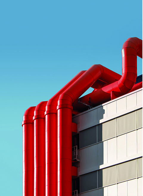 Red pipes on building