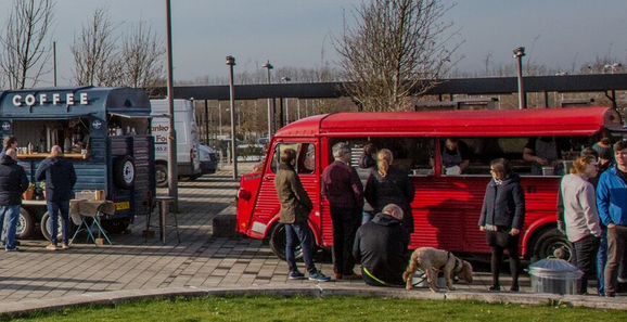 People gathered around food trucks