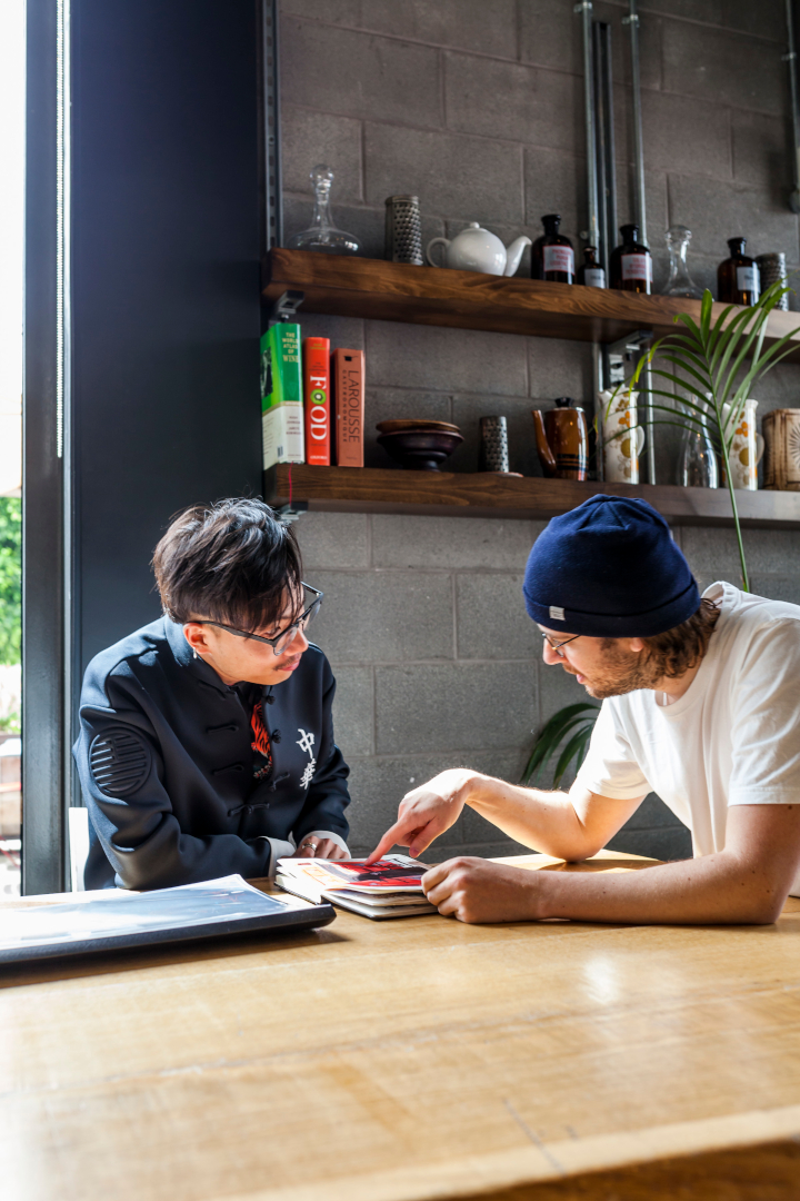 Bo Yang discussing a book with another man