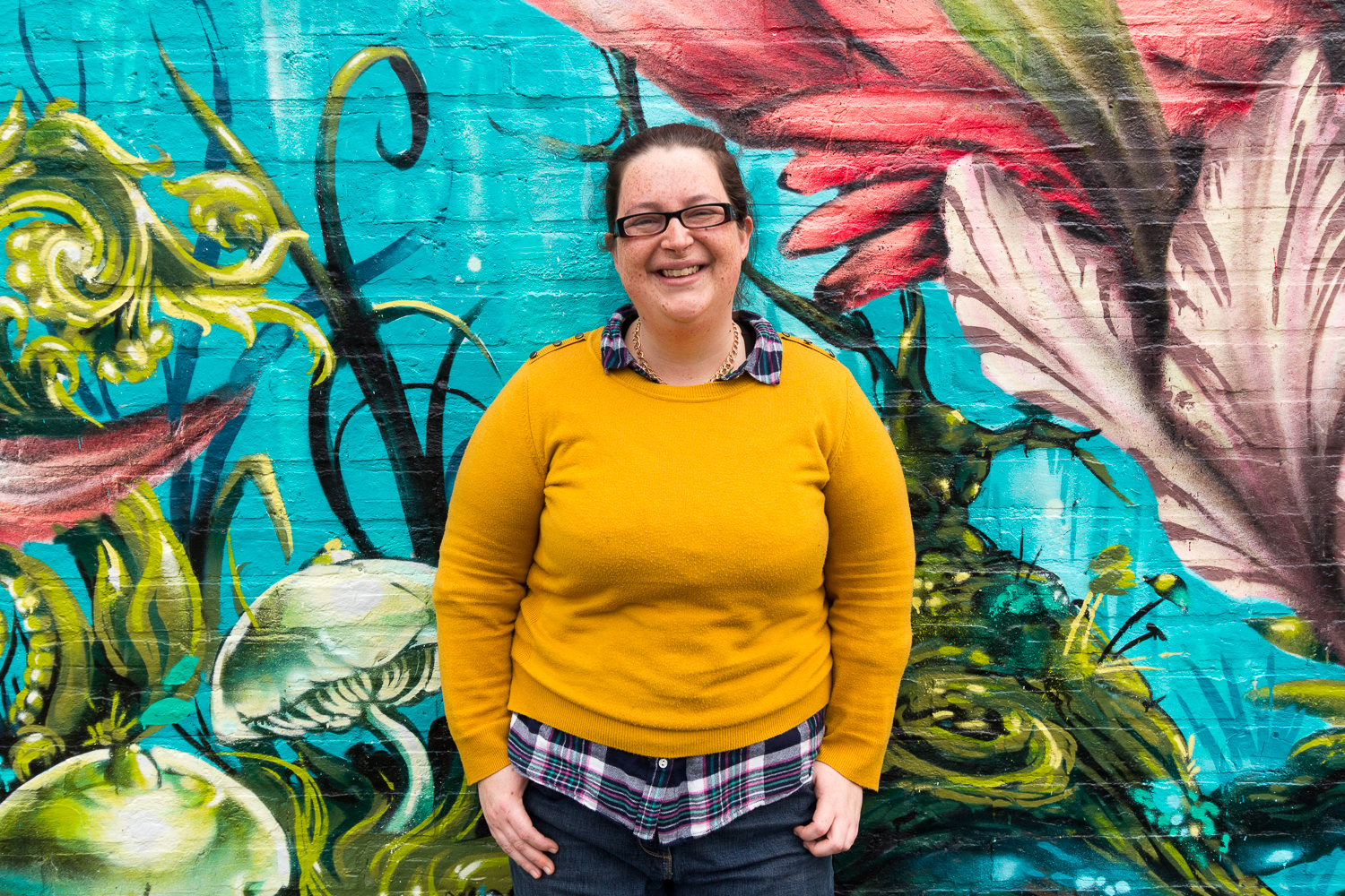 Jemima Willcox in front of a colourful wall mural