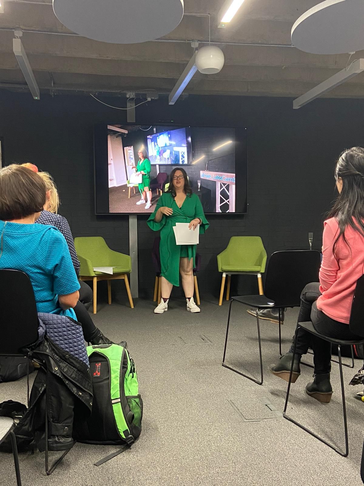 A woman giving a presentation to a room of people